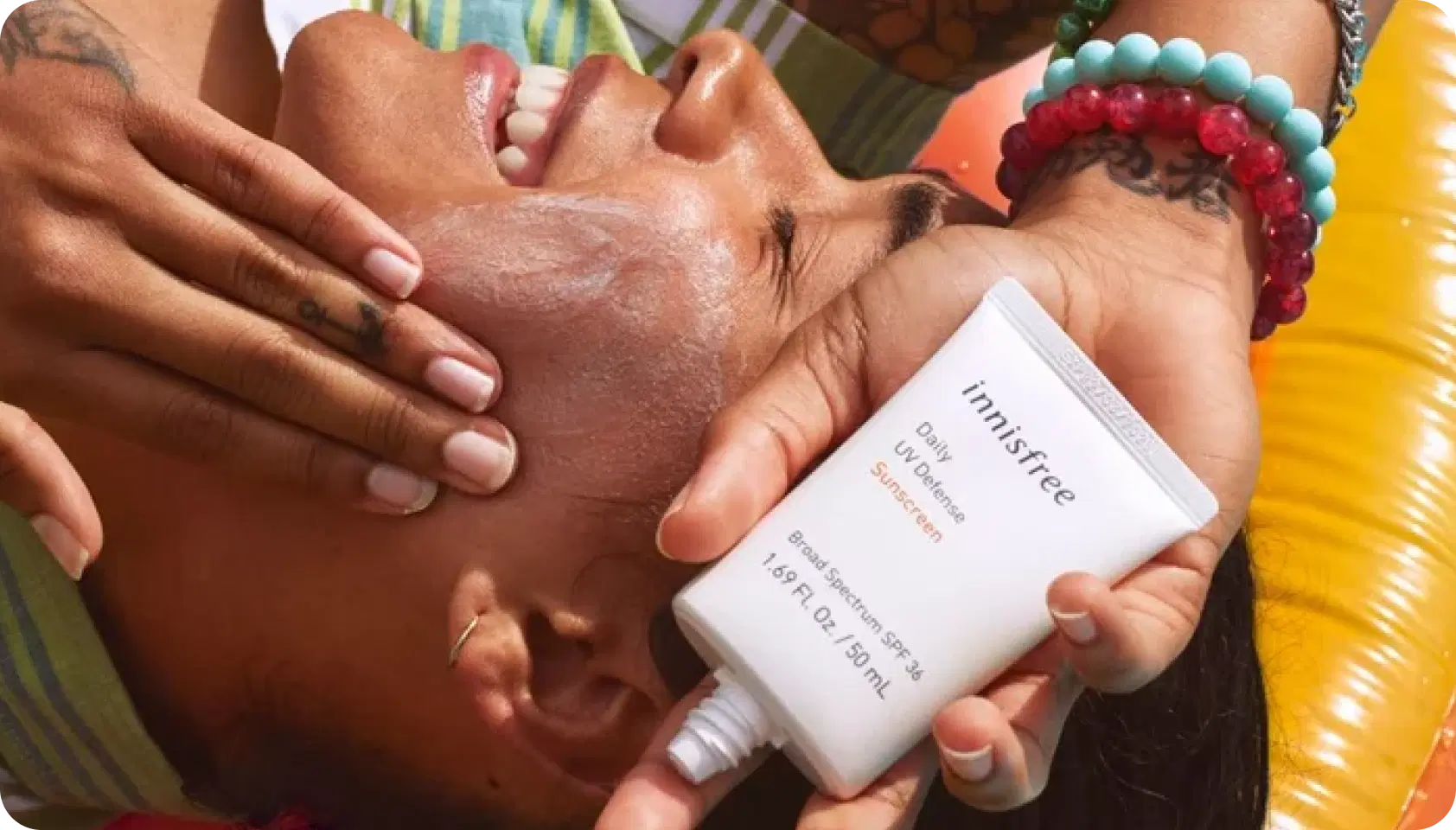Person applying sunscreen in bright sunlight