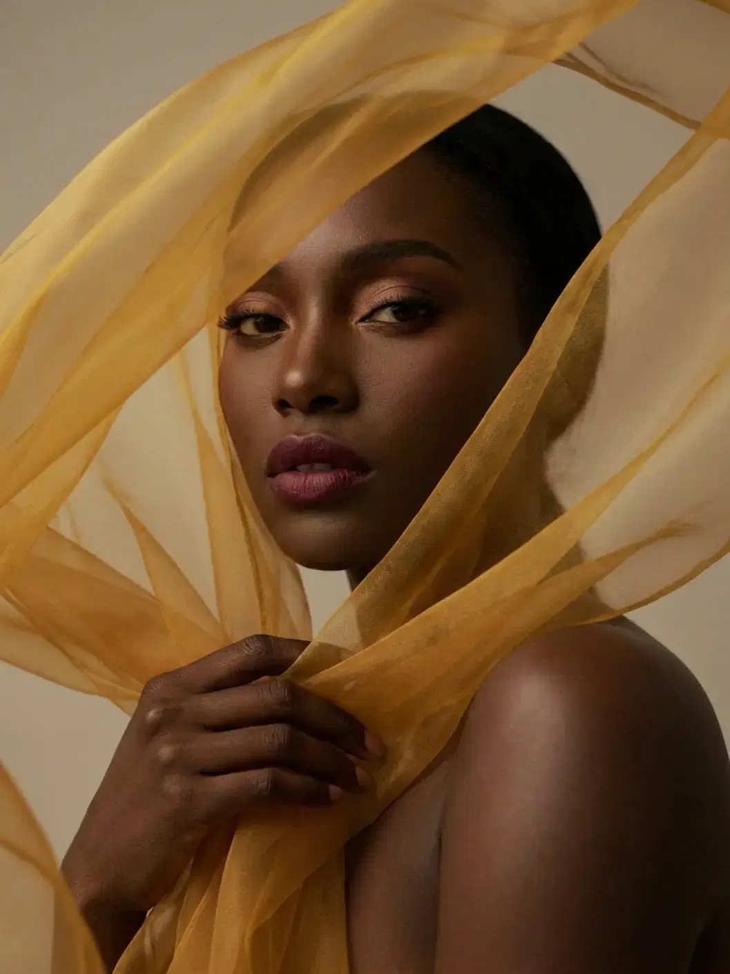 Model with gold scarf for AI editing tools